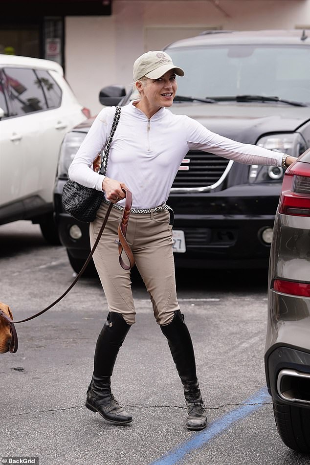 She looked cheerful as she got into her SUV after stopping to pick up some belongings