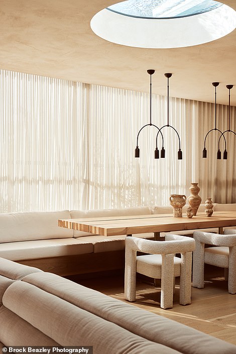 Sheer curtains billow in the wind and, when drawn, create a heavenly soft light to complement the home's neutral color palette and earthy textures