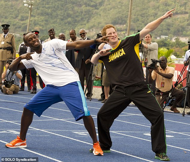 Prince Harry imitates Usain Bolt's signature gesture after a 100-metre race against the world record holder in Jamaica in 2012