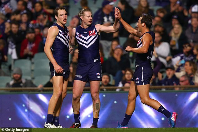 The 29-year-old (pictured center) played 49 games and scored 63 goals for Fremantle during his four-season spell at the club