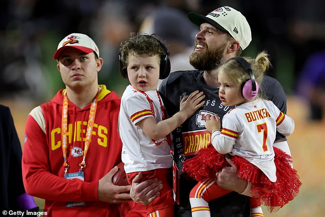 Harrison Butker of the Kansas City Chiefs celebrates with his children after kicking the green field goal to beat the Philadelphia Eagles in Super Bowl LVII at State Farm Stadium on February 12, 2023 in Glendale, Arizona