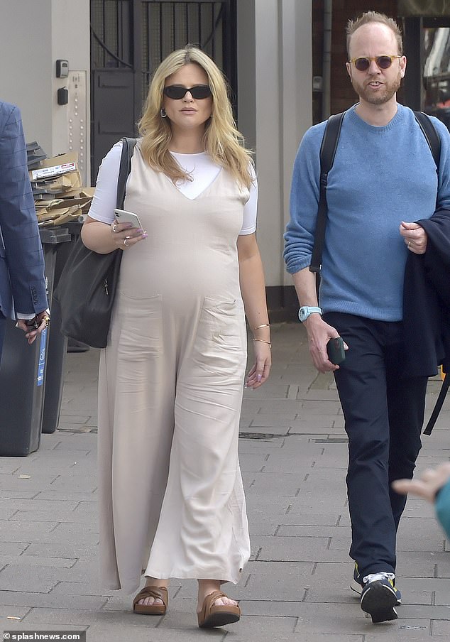 Atack, who is expecting her first child with boyfriend Alistair Garner, wore linen dungarees as she ventured out to London with a friend.