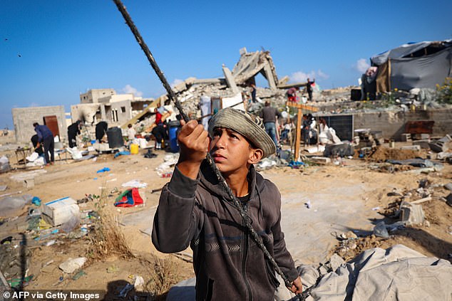 Displaced Palestinians pack their belongings and tents before leaving an unsafe area in Rafah on May 15, 2024, as Israeli forces continued to battle and bomb Hamas militants around the southern Gaza Strip city