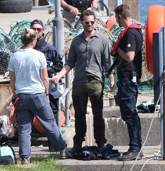 Jamie was later seen wearing a brown shirt and khaki green trousers, shielding his eyes behind stylish sunglasses