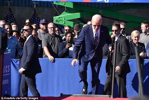 US President Joe Biden trips on the stairs ahead of his remarks on Israel in Philadelphia, Pennsylvania in October 2023.