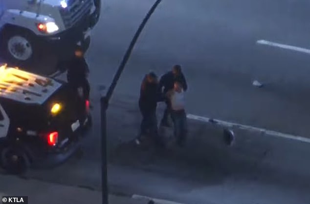 The woman was taken into custody and taken to the hospital, and at least one LAPD officer was also transported to the hospital for injuries sustained during the chase.