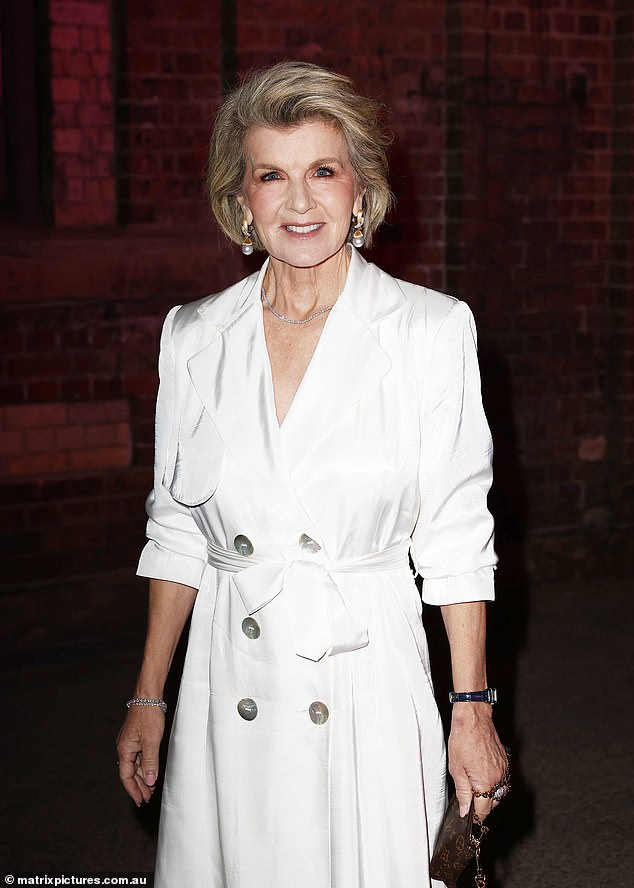 Meanwhile, the fashion icon was all smiles on Thursday as she posed in a stylish white trench coat-inspired dress at the David Jones Indigenous Fashion Projects event