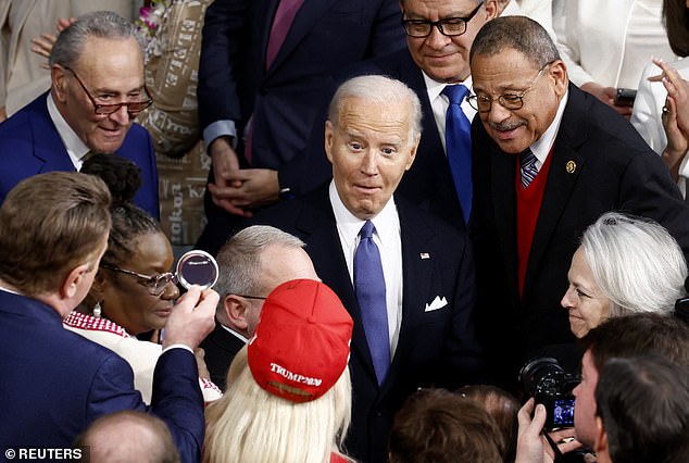 Biden reacts as he looks at U.S. Rep. Marjorie Taylor Greene during the State Of The Union in March as he walks into Congress