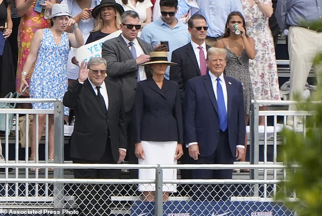 Donald Trump stands with Melania Trump and her father, Viktor Knavs, at the graduation ceremony for his son Barron at the Oxbridge Academy in West Palm Beach, Florida, on Friday