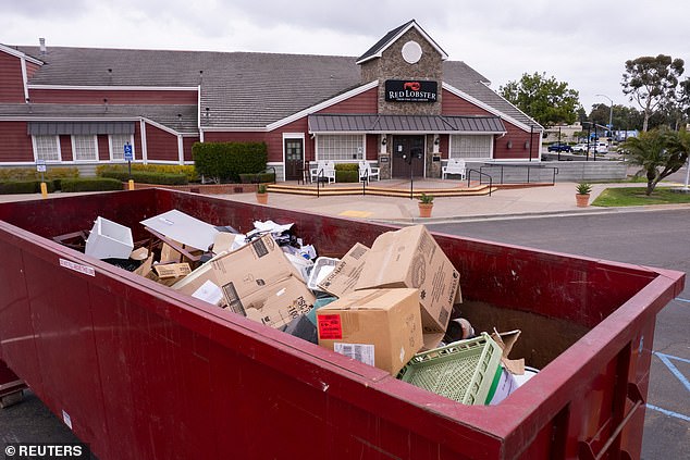 A dumpster is shown in front of a closed Red Lobster restaurant with its entire contents up for auction in San Diego, California