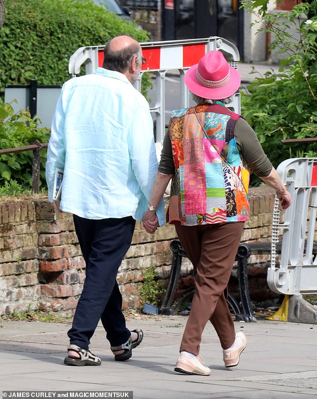 She and David were the picture of happiness as they enjoyed a fun stroll together in London