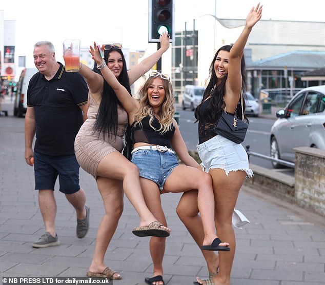 Sarah Benzid, 23, Daisy Mae, 20, and Grace Lexa, 20, from Sheffield, South Yorkshire, partying in Skegness last night