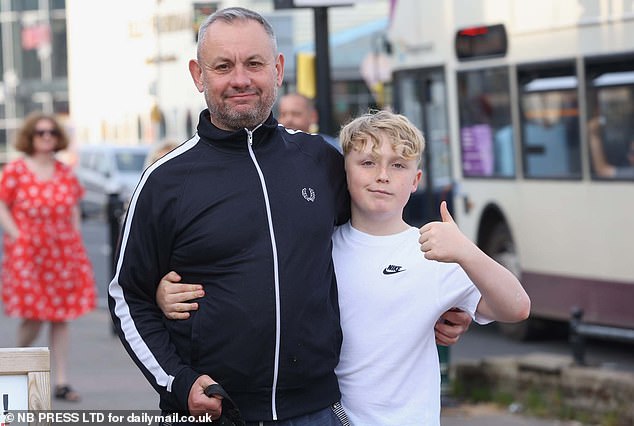 Dave Bond, 55, from West Yorkshire, shared a chip supper with son Alfie, 12, Staffordshire bull terrier Barney, who strained for leftovers in the lead, while Dave considered getting another tattoo during their stay