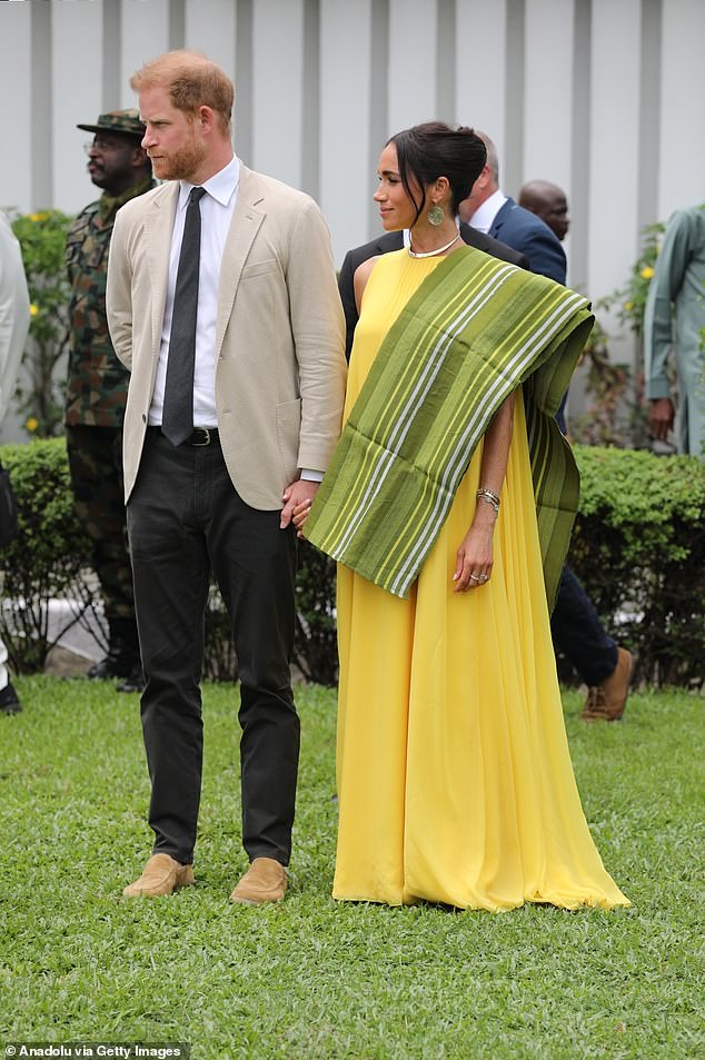 In Lagos, Meghan wore a Carolina Herrera column dress with silk overlay in 'taxi cab' yellow
