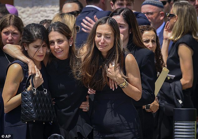 After Adler's funeral service in Miami on Monday, mourners support each other as they leave Temple Beth Sholom