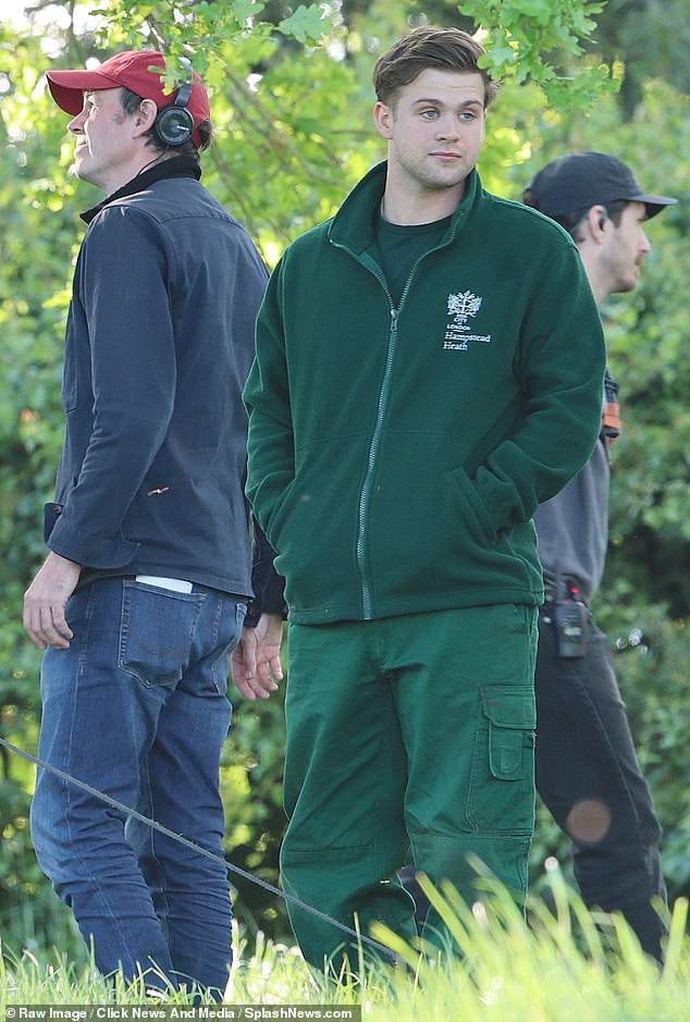 Leo Woodall, one of the stars of hit series One Day, is dressed in a green t-shirt and matching trousers - the uniform of rangers at Hampstead Heath