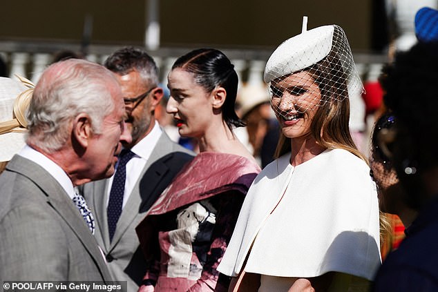 Rosie Huntington-Whiteley (pictured) - who wore an elegant white dress and cape with matching hat - showed up