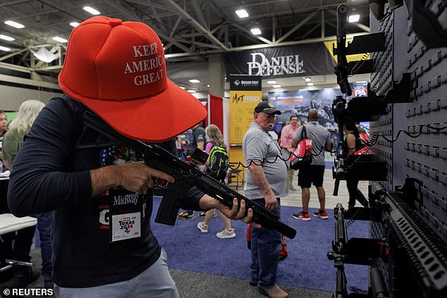 Danny Batsalkin holds a rifle during the National Rifle Association (NRA) annual meeting in Dallas, Texas, USA, May 18, 2024