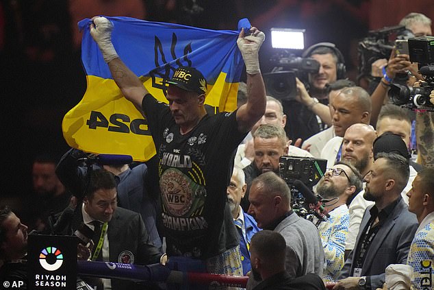 After being crowned the new undisputed champion, Usyk stood at the ropes and held up a Ukrainian flag