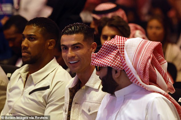 Cristiano Ronaldo (center) sat in the front row, next to Anthony Joshua (left)