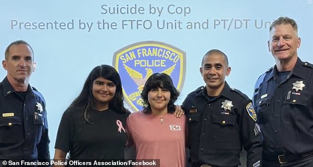 The girl, center, is seen standing next to officers who have undergone training to prevent incidents of 'suicide by cop'