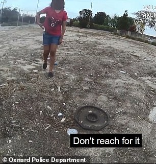 The officer in the video repeatedly orders the young woman to throw away the knife