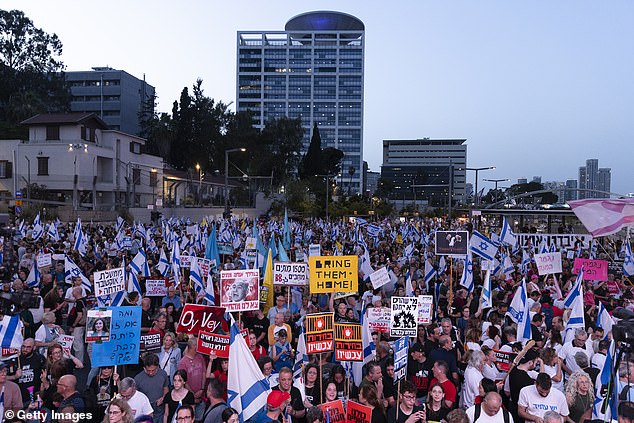 Protesters in Tel Aviv Saturday evening.  Critics of Netanyahu, including thousands who have joined weekly protests in recent months, accuse him of prolonging the war for his own political survival.