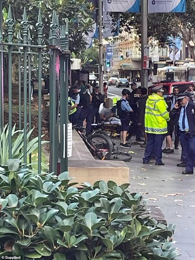 NSW Police confirmed a 33-year-old man has been arrested and taken to hospital for assessment (Photo: A man is treated at the scene)