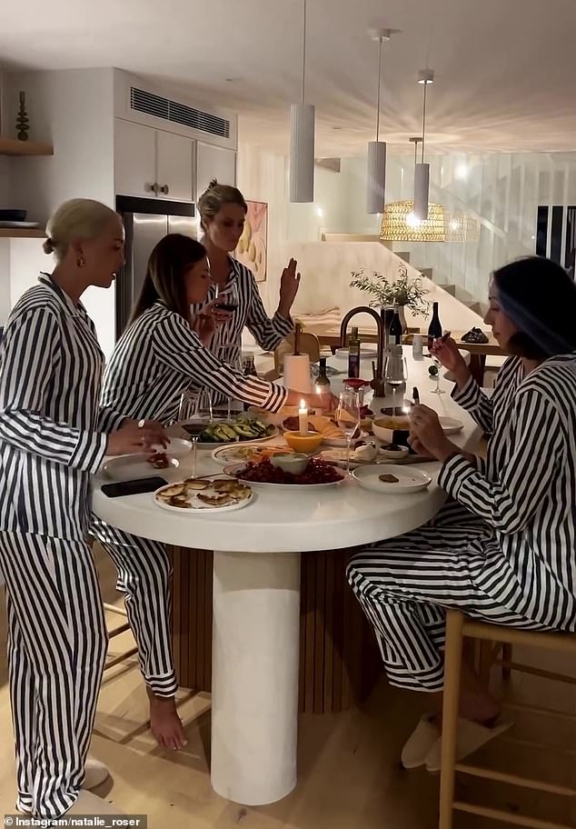 The women all wore matching black and white striped silk pajamas, and it didn't take long for several followers to notice that their outfits resembled prison uniforms.