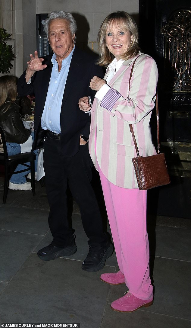 Model Twiggy looked chic as she opted for a pink ensemble for the double date, wearing a cream and fuchsia striped blazer over a white shirt