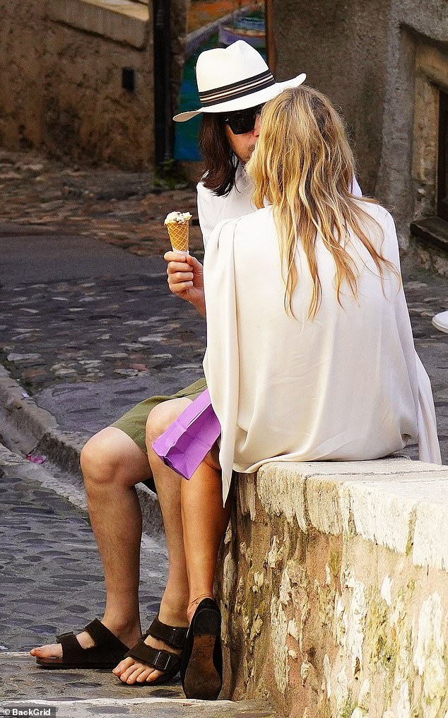They sat on a wall and talked while eating their ice creams