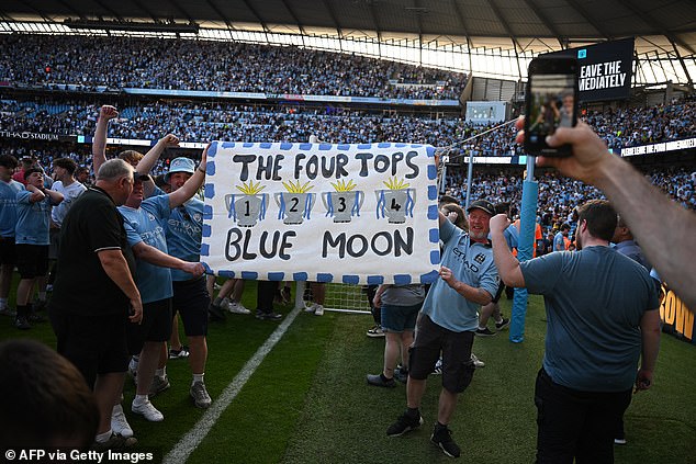 Manchester City fans storm the Etihad pitch after their side's historic Premier League title win