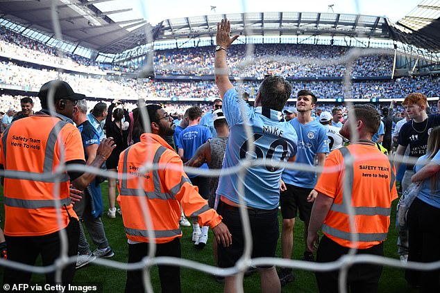 City fans on the pitch at the final whistle