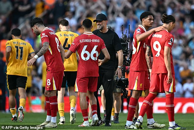 Klopp smiles as he thanks his players on the pitch in his last game in charge