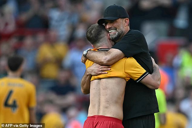 The 56-year-old German tightly hugs Argentina midfielder Alexis Mac Allister in emotional scenes at Anfield
