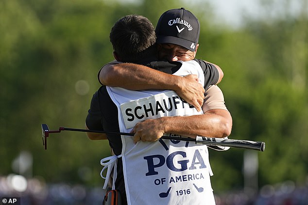 Schauffele hugged Austin Kaiser, his caddie and former teammate at San Diego State