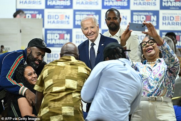 President Joe Biden poses for a photo during a campaign stop in Detroit, Michigan at the CRED Cafe on Sunday.  He had a lighter touch with former President Donald Trump than in recent appearances