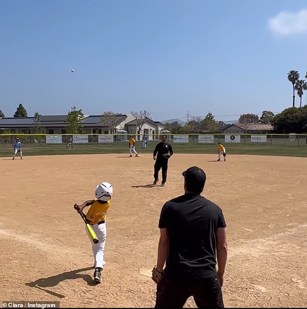 The proud mother let her son hit a home run during his baseball game