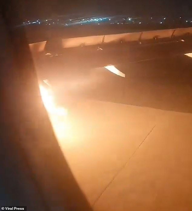 Once the plane is back on the runway, passengers are told by a public address system to remain seated as the fire appears to be getting more intense