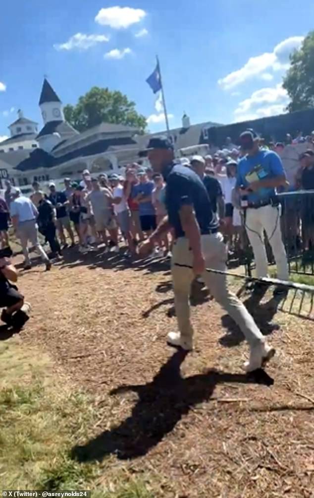 DeChambeau turned and approached the group of fans after an adult grabbed the ball