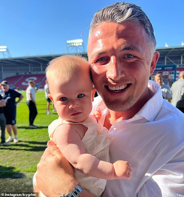 The former South Sydney Rabbitohs star, 35, looked every bit the doting dad as he cradled his eight-month-old daughter Robbie, showing off silver hair and straighter teeth.