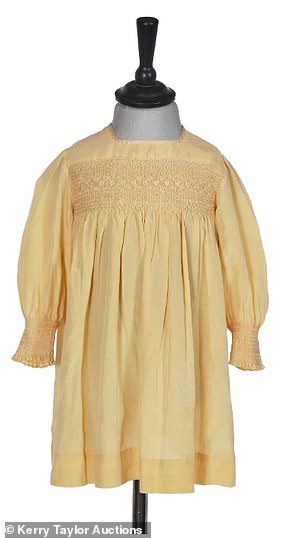 A yellow silk smocked dress, once worn by Princess Elizabeth in 1930