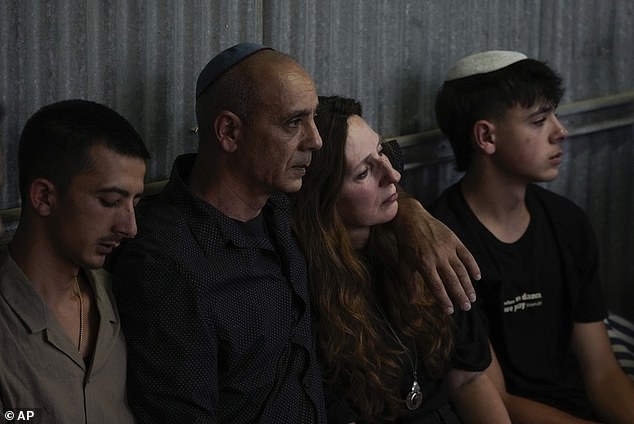 Shani Louk's parents mourn during her funeral in Srigim, Israel on Sunday