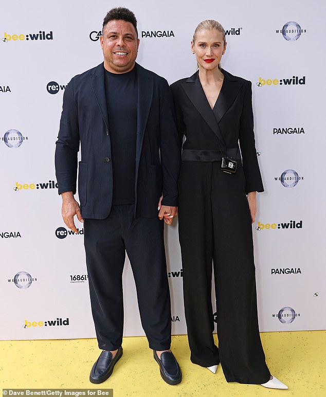 Ronaldo attended with his Brazilian model partner Celina Locks, who wore a black suit-style pantsuit with pointy white heels