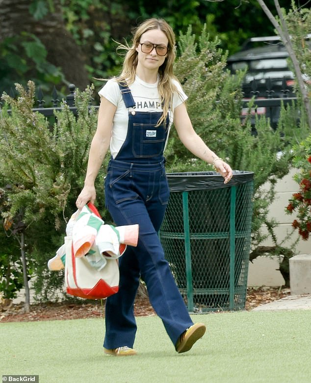 The actress embraced a country-chic look in dark blue denim overalls and a white t-shirt