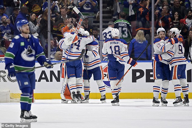 Edmonton held off a Vancouver comeback late in the third period to advance to the playoffs