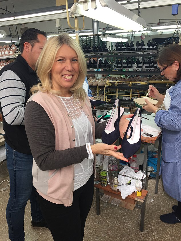 Sole Bliss owner Lisa Kay at her company's factory in Alicante with a pair of finished shoes in hand