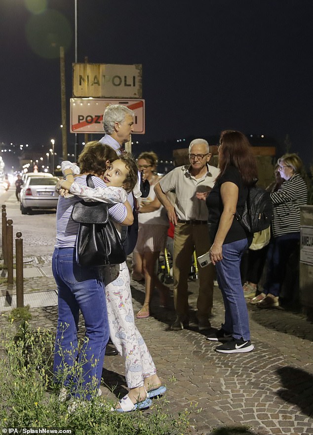 Concerned citizens gather in a safe area along the coast between Naples and Pozzuoli after an earthquake in the evening