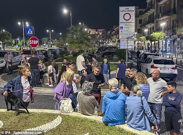 Concerned citizens gather in a safe area along the coast between Naples and Pozzuoli after an earthquake in the evening