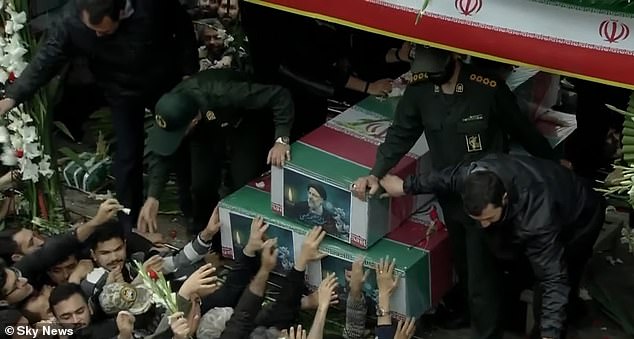 Mourners rush to touch the coffins of the dead